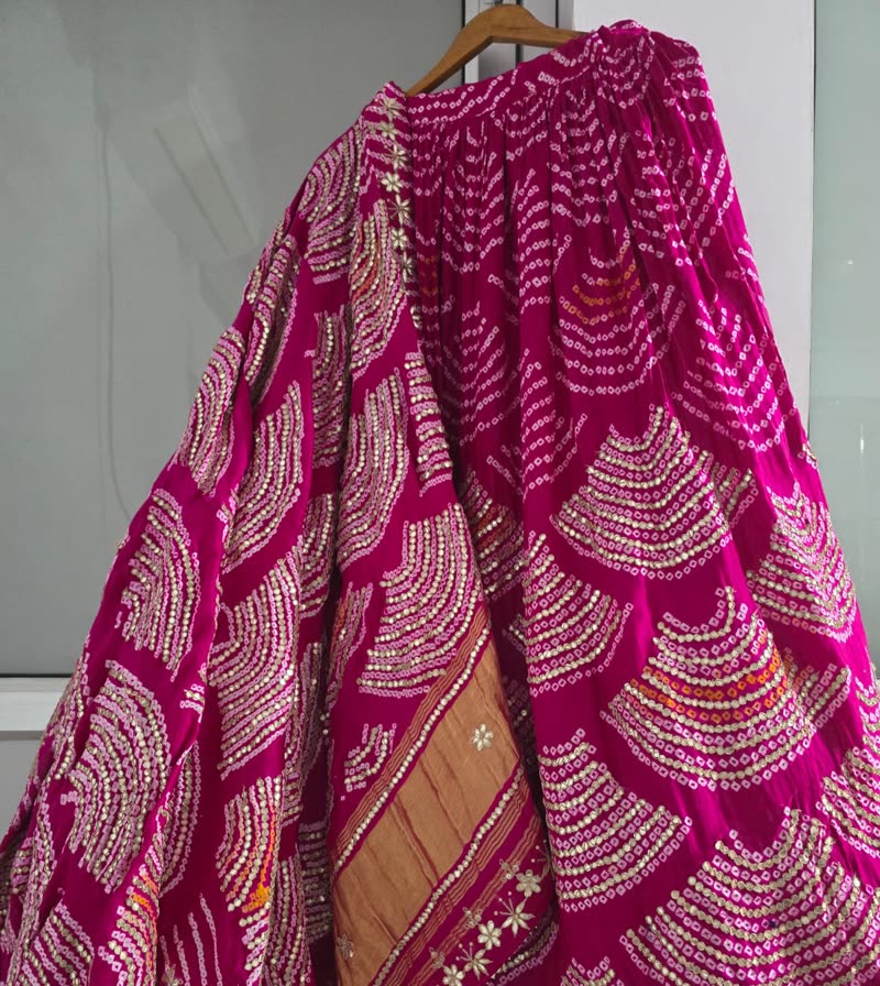 A bandhani lehenga skirt on a hanger